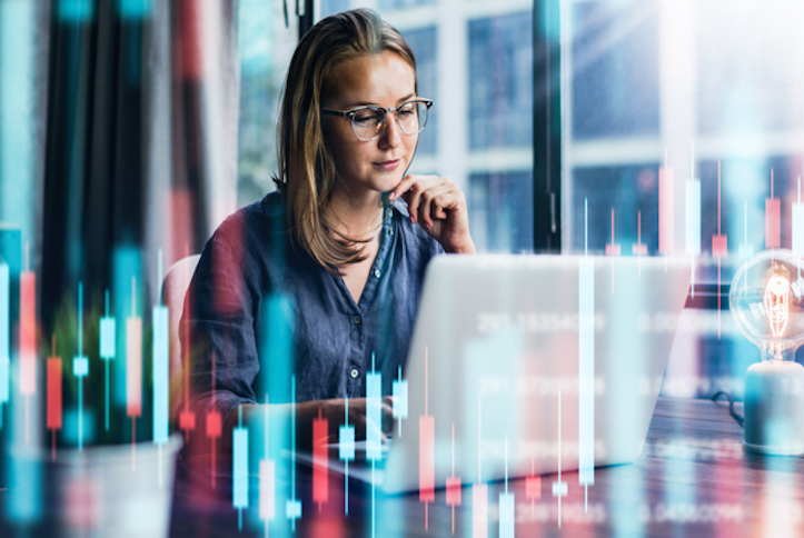 Businesswoman working at modern office.Technical price graph and indicator, red and green candlestick chart and stock trading computer screen background. Double exposure. Trader analyzing data